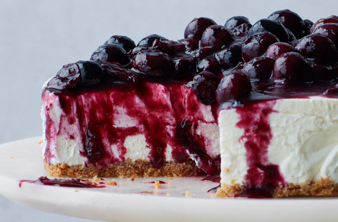 image of vanilla cheesecake with blueberry compote